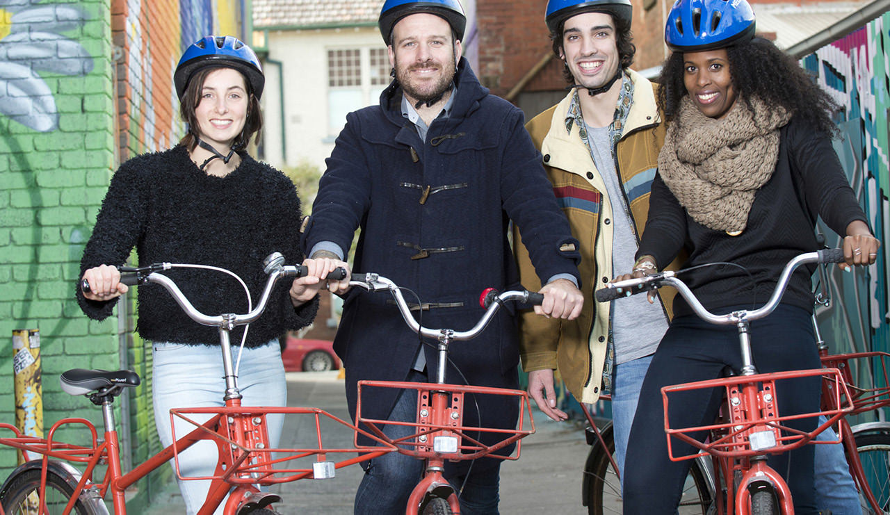 Group of people on donated refurbished postie bikes