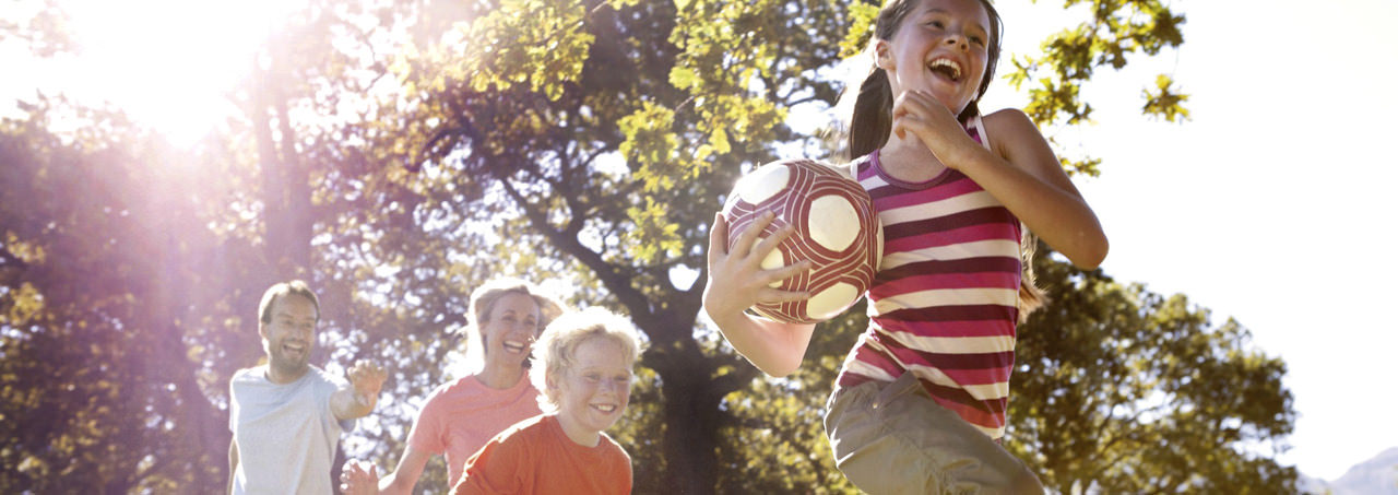 Children running with soccer ball