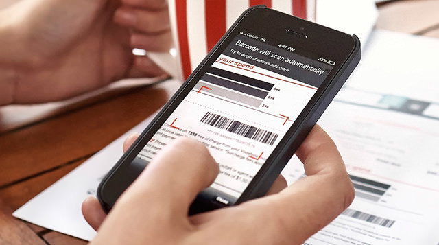 Close-up of a customer using their smartphone to pay a bill using a barcode