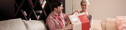 Image of man and woman opening parcel