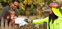 Father with his child collecting mail at the gate