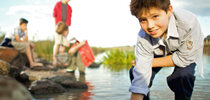 Kids playing in a clean creek