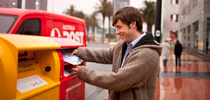 Young man sending mail