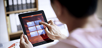 Business woman accessing internet from a tablet