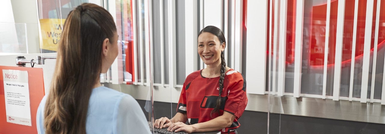 Photo of a woman serving a customer at Post office
