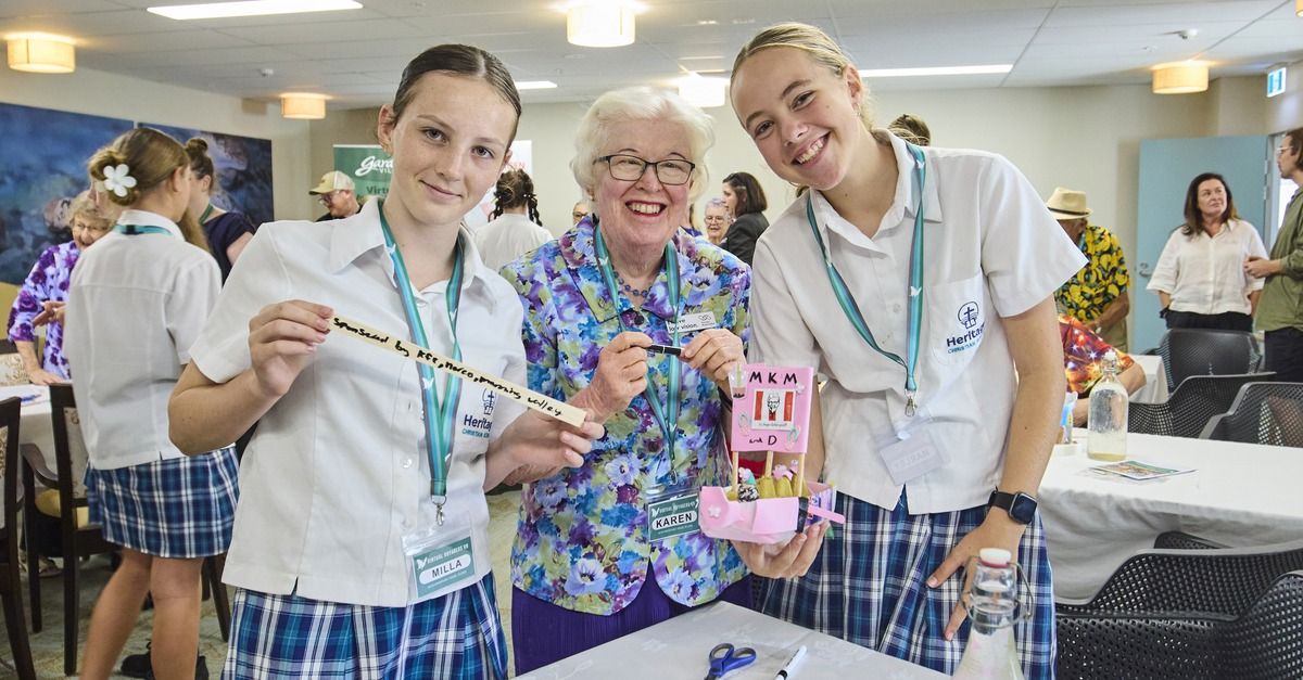 Two female school students with and elderly woman
