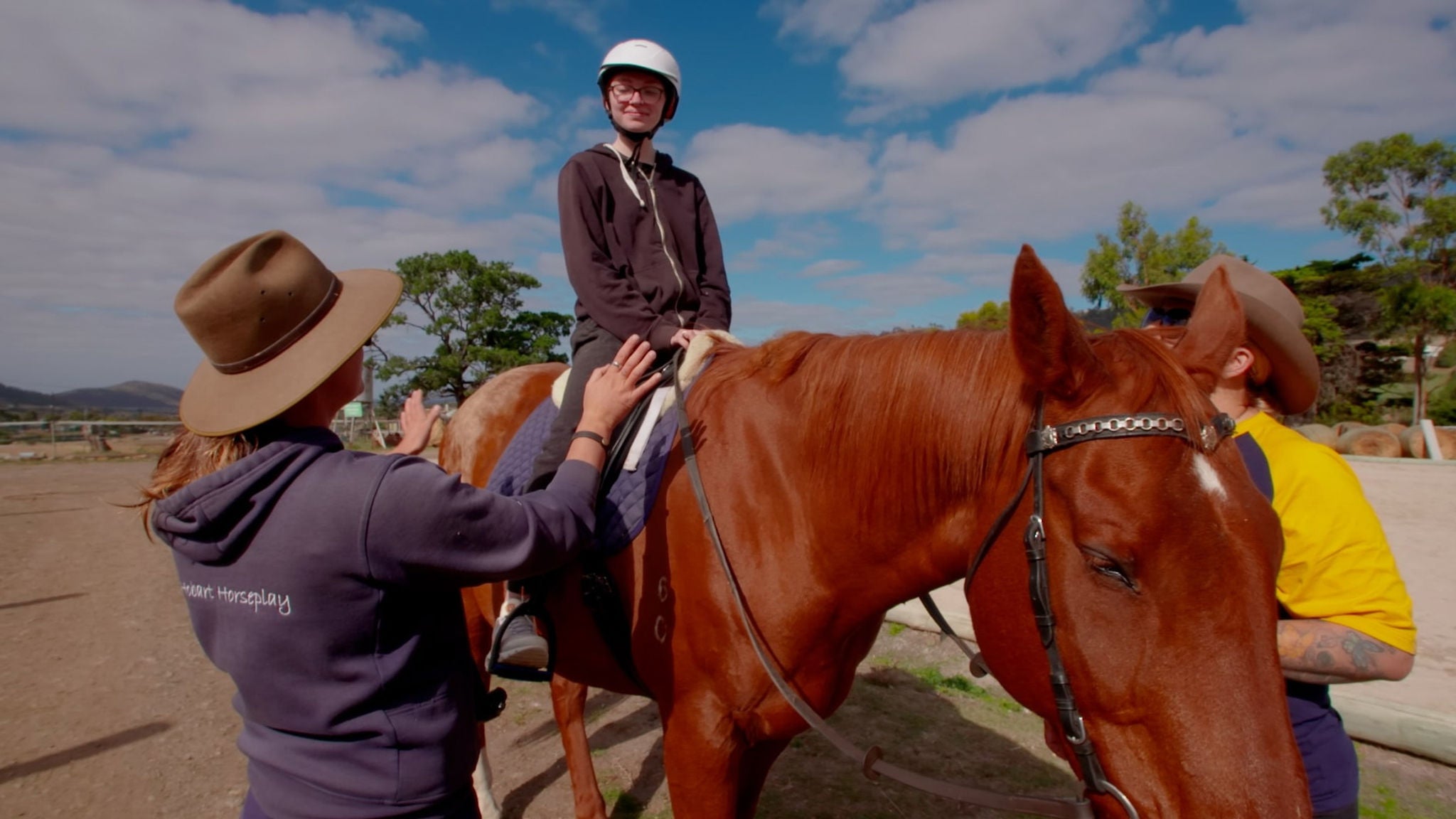 Teenage girl from West Moonah Community House riding a horse.