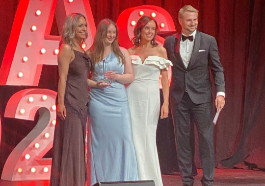 An image of our Australia Post team members on stage accepting the Internal Talent Award