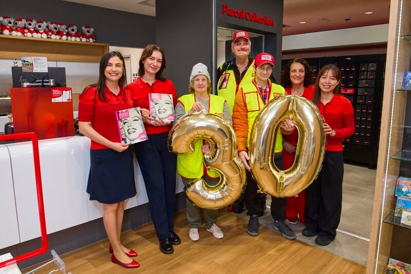 Big Issue vendors in a post office