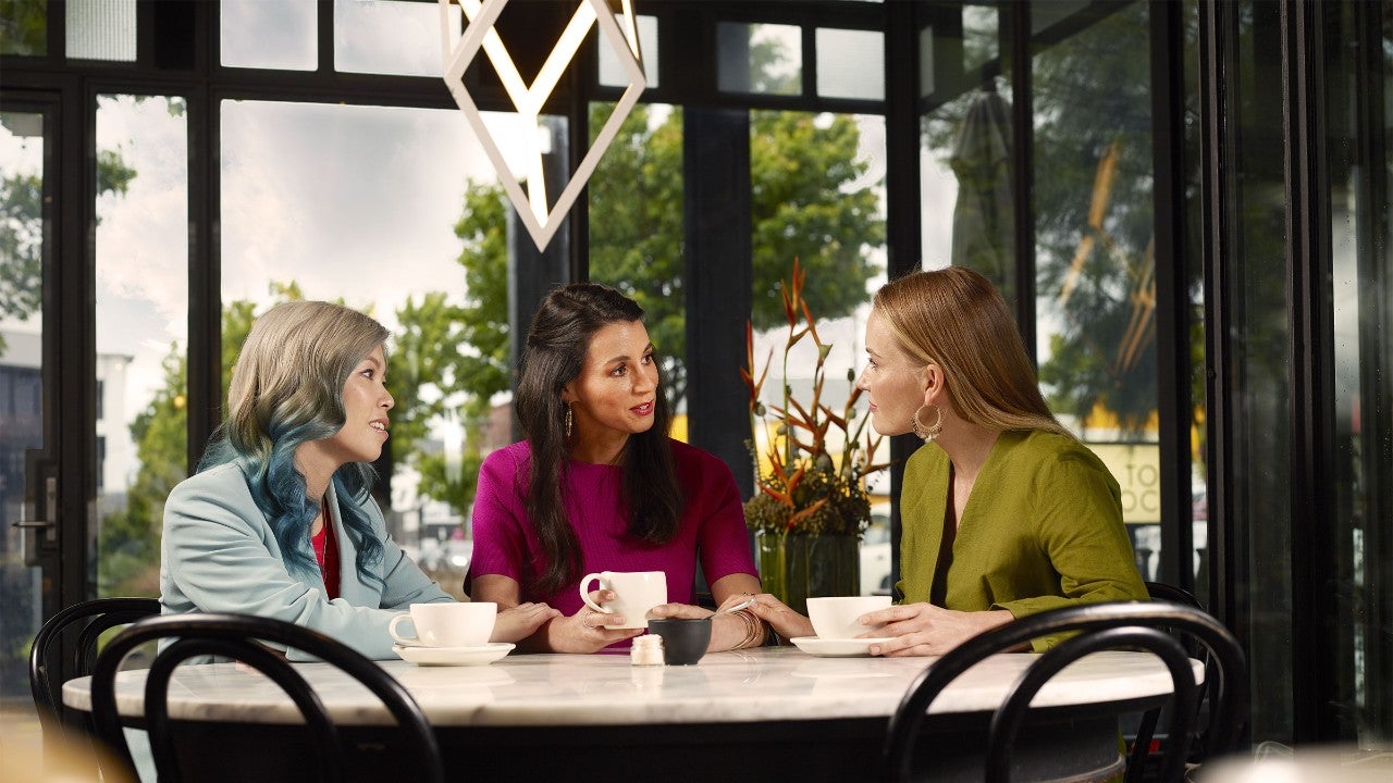 Photo of three women meeting over a coffee
