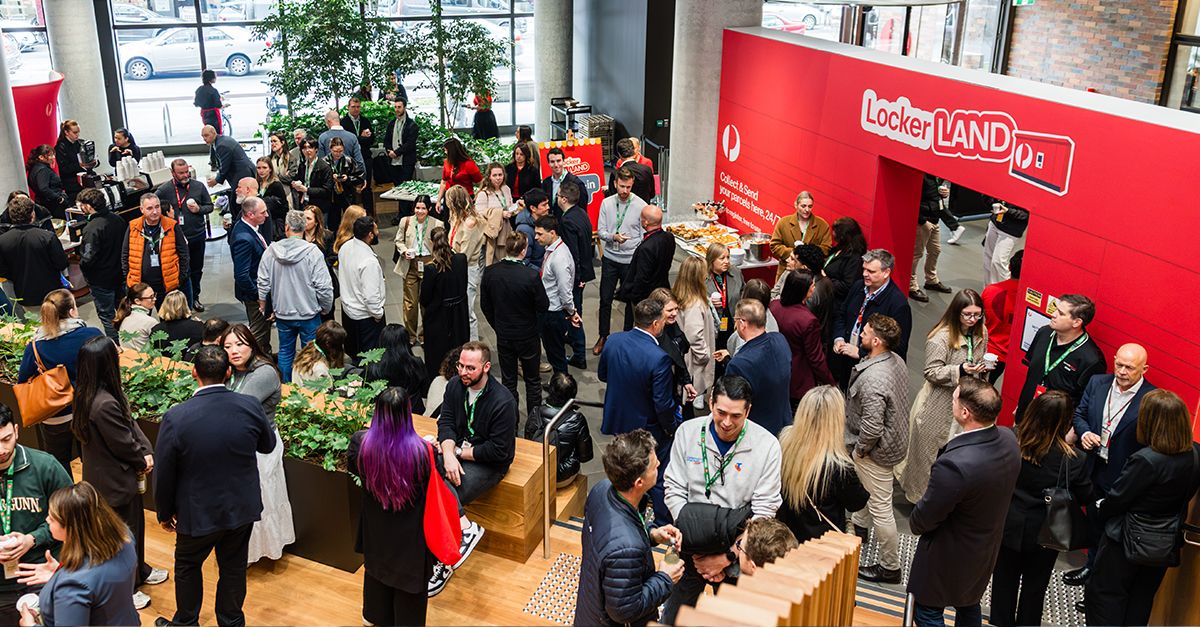 A large group of attendees mingling at the Locker Land event, with a red sign that says 'Locker Land' in the background.