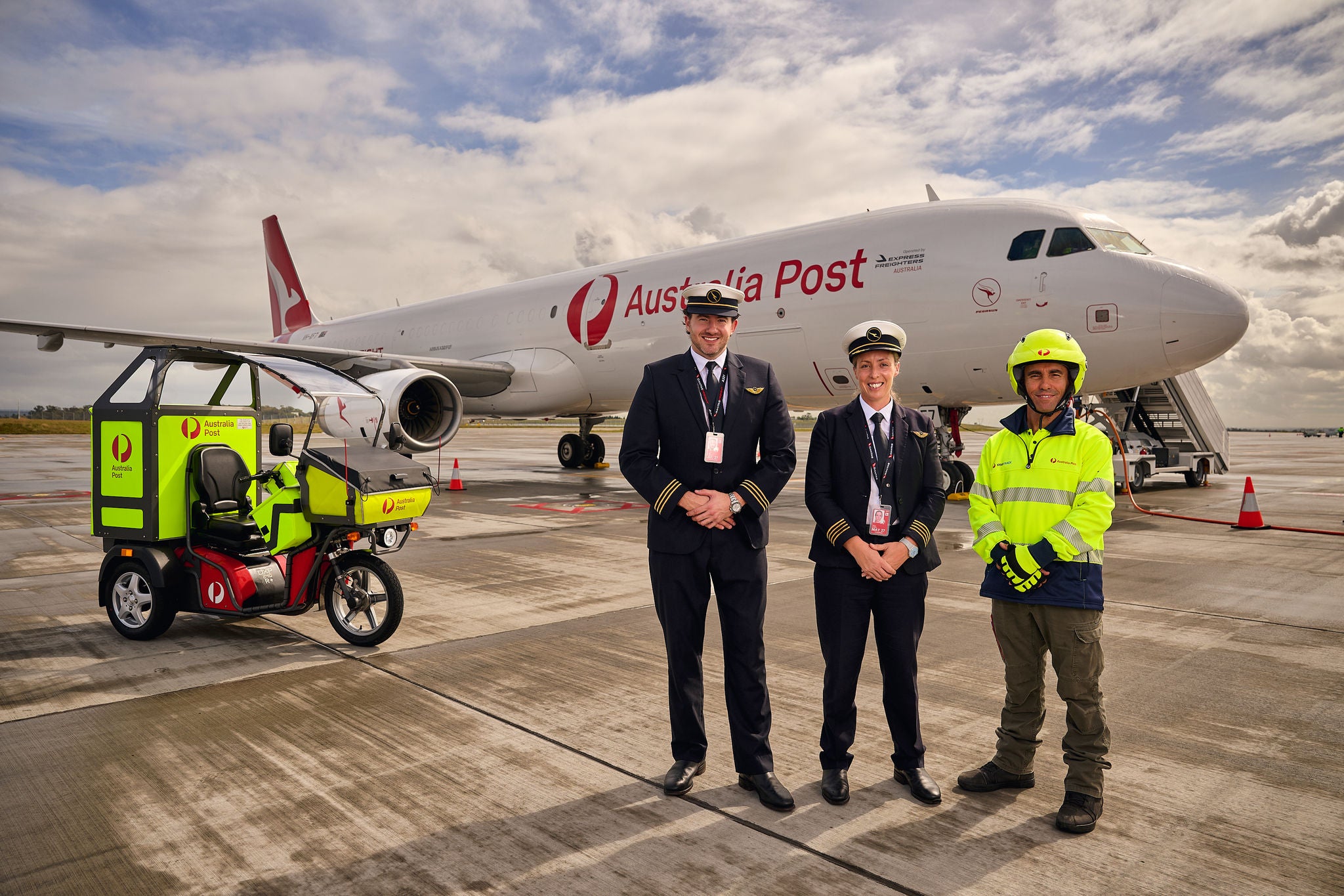 A new Airbus, Pilots and a postie standing in front on the tarmac. A EDV is also shown in the background