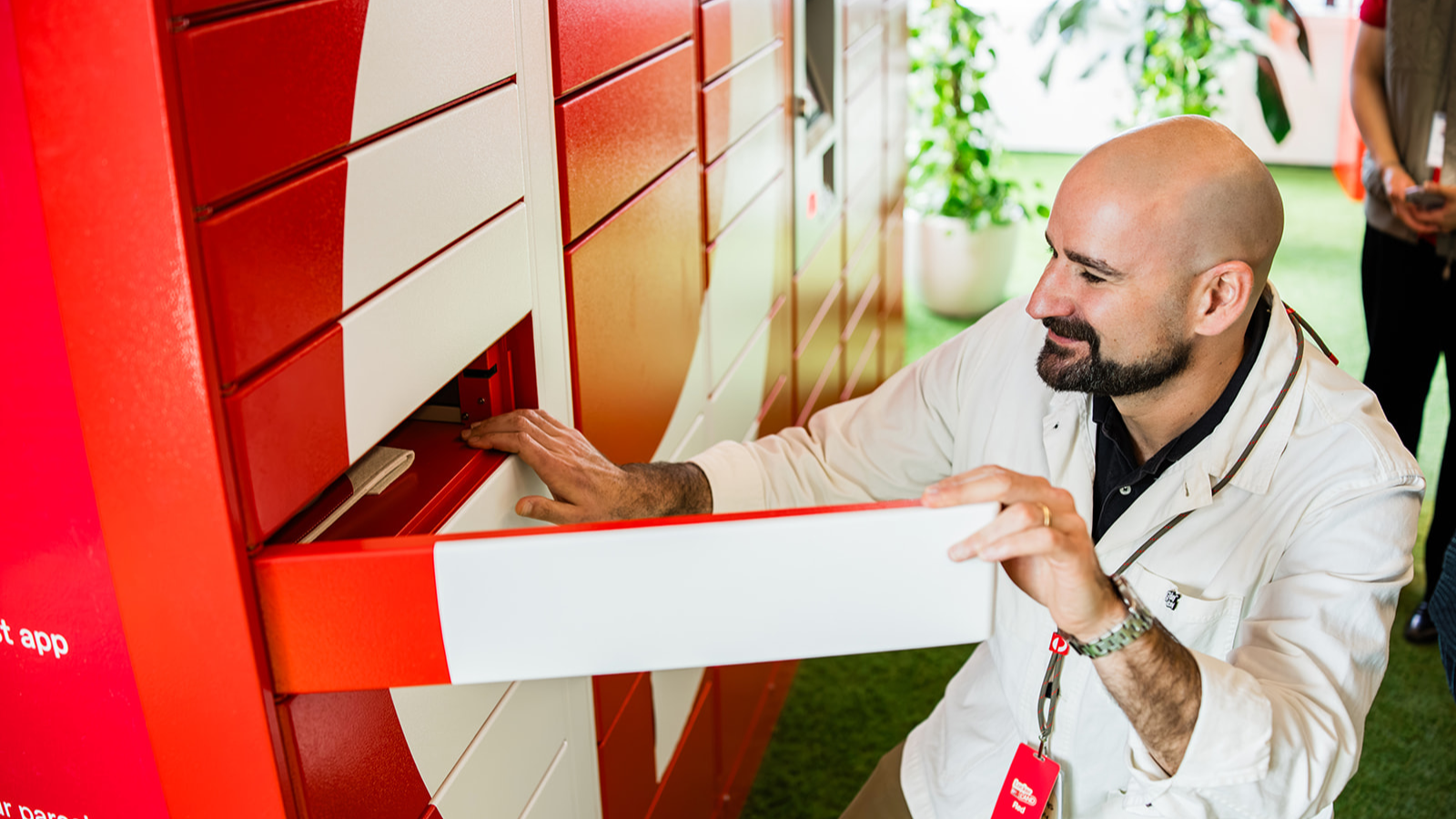Locker Land attendee opening a Parcel Locker compartment at the Locker Land experience.
