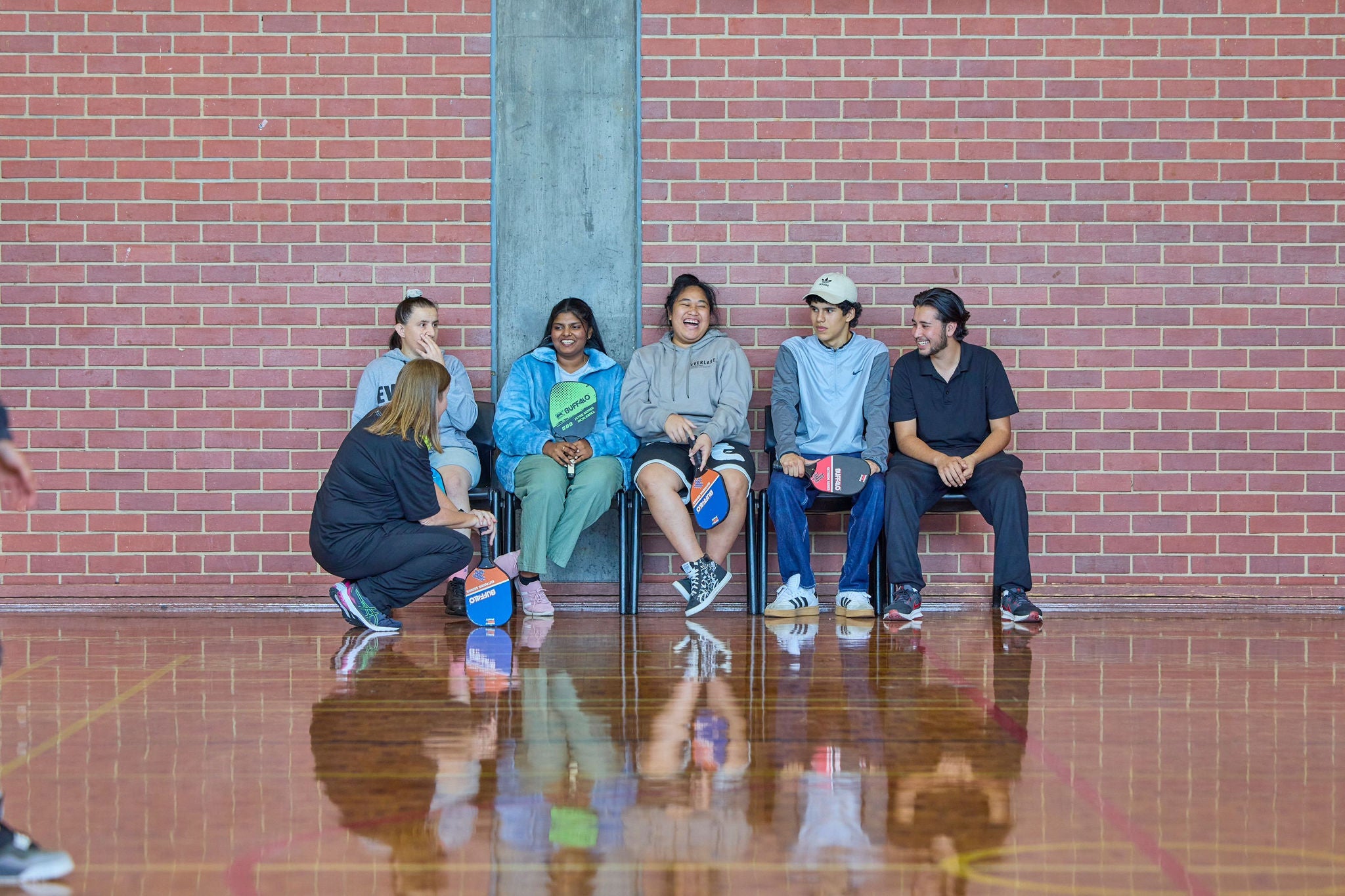 A group of people sitting outside and drinking a cuppa