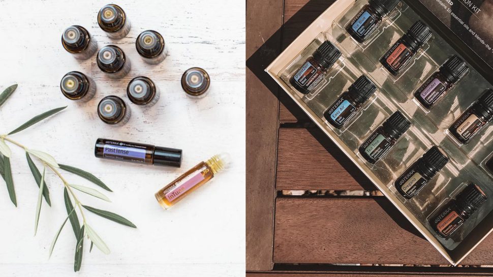 Small bottles of essential oils laid out on a table and in a box. 