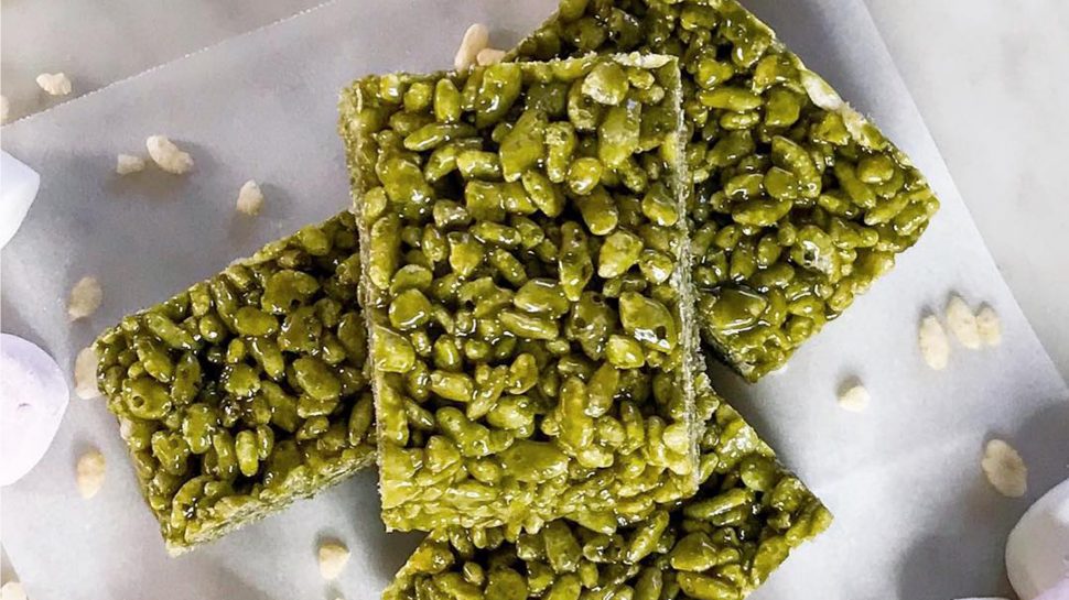 A stack of green matcha rice krispies on a white plate