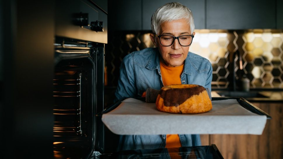 https://auspost.com.au/content/dam/auspost_corp/media/images/photo-mature-woman-taking-a-cake-out-of-the-oven.jpg.auspostimage.970*0.169.medium.jpg