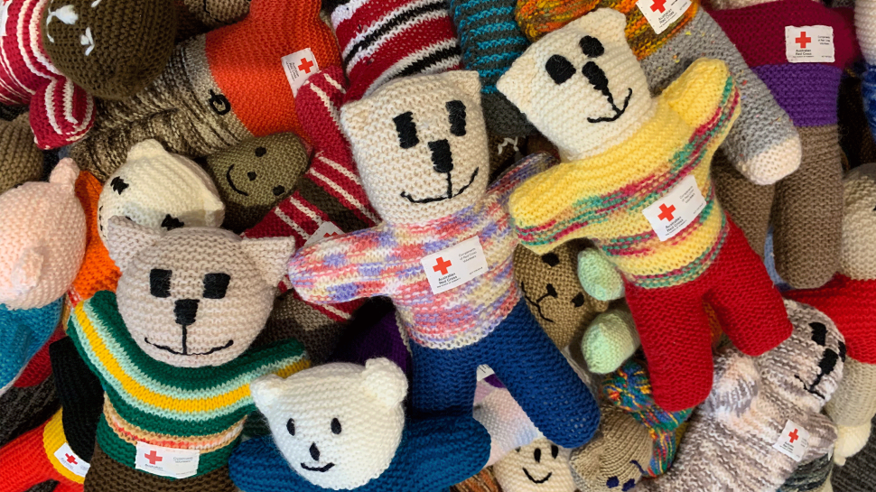 A close-up of colourful knitted teddy bears.
