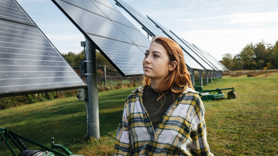 Woman walking past sustainable solar panels
